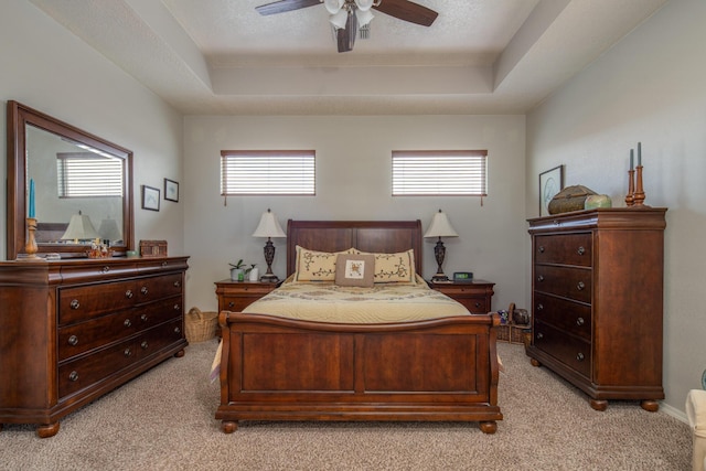 1978 Castle Peak Loop NE, Rio Rancho, NM 87144 - bedroom with a tray ceiling, light carpet, and a ceiling fan