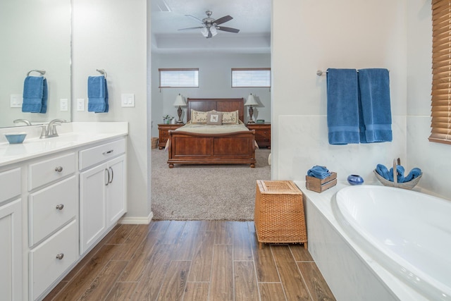 1978 Castle Peak Loop NE, Rio Rancho, NM 87144 - bathroom featuring vanity, ceiling fan, a garden tub, and wood finished floors