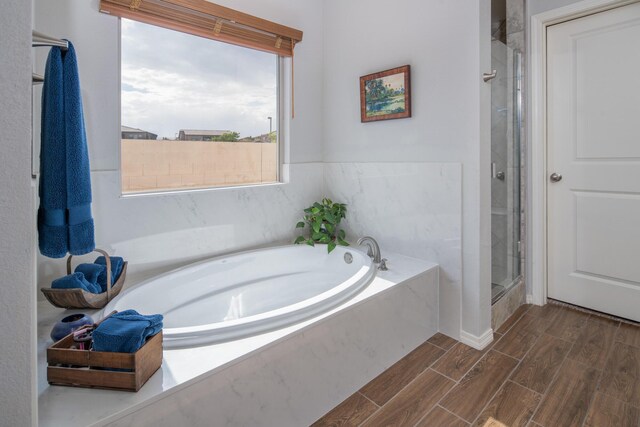 1978 Castle Peak Loop NE, Rio Rancho, NM 87144 - full bath featuring a shower stall, wood tiled floors, and a bath
