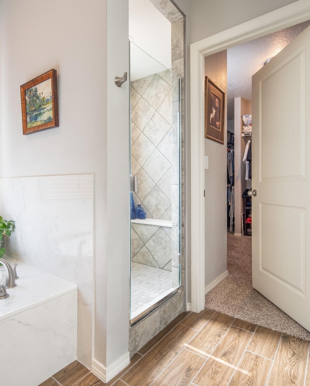 1978 Castle Peak Loop NE, Rio Rancho, NM 87144 - bathroom with wood finished floors, a stall shower, a spacious closet, and a garden tub
