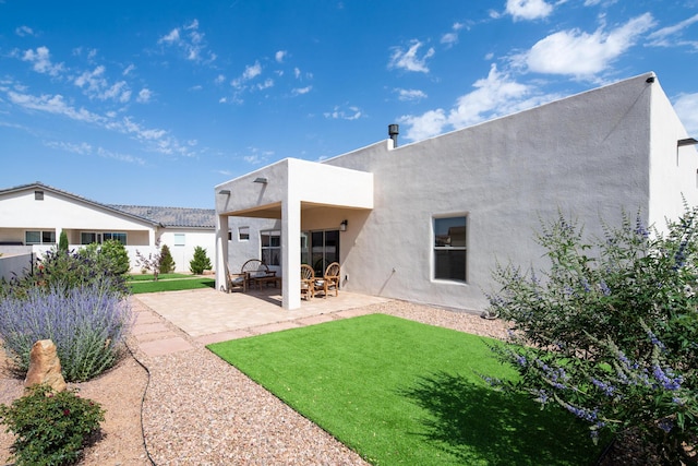 1978 Castle Peak Loop NE, Rio Rancho, NM 87144 - rear view of property with a patio, stucco siding, and a lawn
