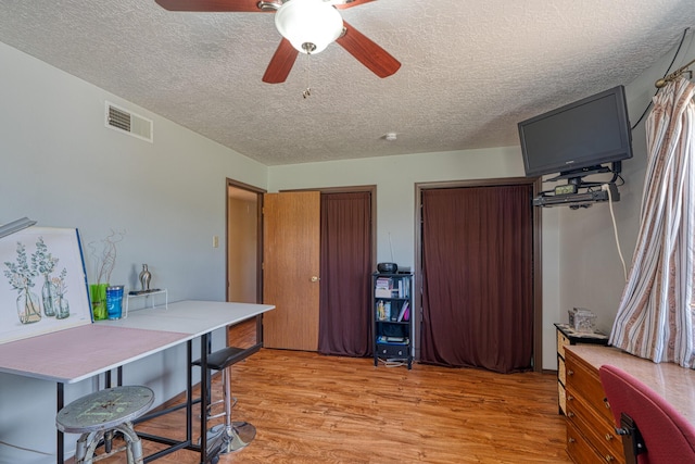 1 Dinosaur Rd, Stanley, NM 87056 - office with light wood finished floors, ceiling fan, and a textured ceiling