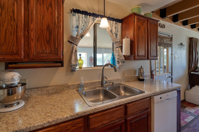 1 Dinosaur Rd, Stanley, NM 87056 - kitchen with dishwasher, light countertops, decorative light fixtures, and brown cabinetry