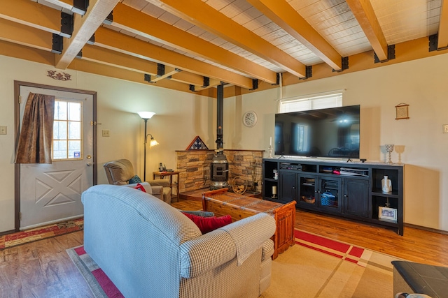 1 Dinosaur Rd, Stanley, NM 87056 - living room featuring light wood finished floors, beamed ceiling, and a wood stove