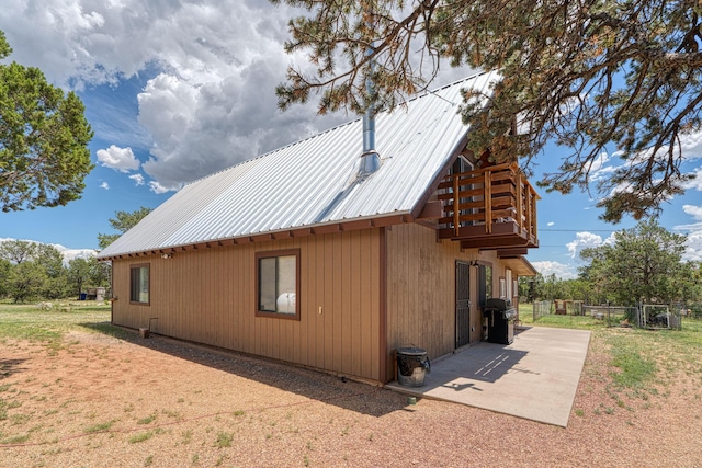 1 Dinosaur Rd, Stanley, NM 87056 - view of side of home featuring a metal roof and a patio area