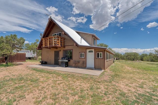 1 Dinosaur Rd, Stanley, NM 87056 - back of property with a patio, a lawn, a balcony, and a metal roof