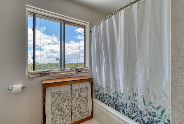 1 Dinosaur Rd, Stanley, NM 87056 - full bath with healthy amount of natural light, shower / bath combination with curtain, and tile patterned flooring