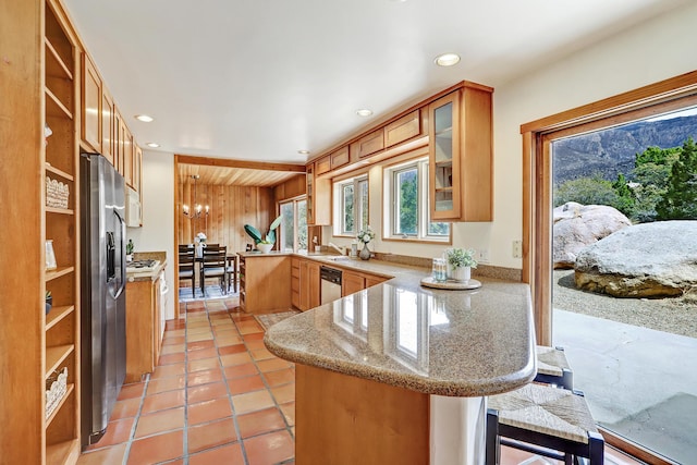 1036 Red Oaks Loop NE, Albuquerque, NM 87122 - kitchen featuring a peninsula, open shelves, stainless steel appliances, glass insert cabinets, and a breakfast bar
