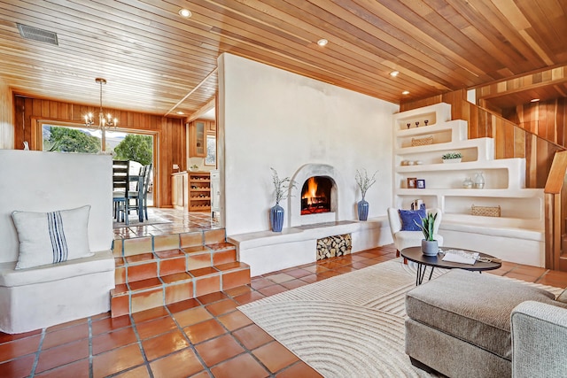 1036 Red Oaks Loop NE, Albuquerque, NM 87122 - living area with a chandelier, wood walls, wood ceiling, a warm lit fireplace, and tile patterned flooring