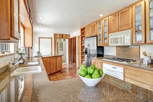 1036 Red Oaks Loop NE, Albuquerque, NM 87122 - kitchen with white appliances, recessed lighting, tasteful backsplash, glass insert cabinets, and a peninsula