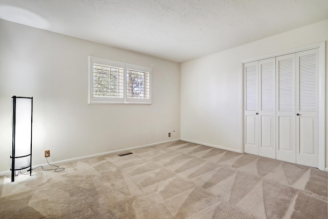 1036 Red Oaks Loop NE, Albuquerque, NM 87122 - unfurnished bedroom with carpet floors, a closet, and a textured ceiling