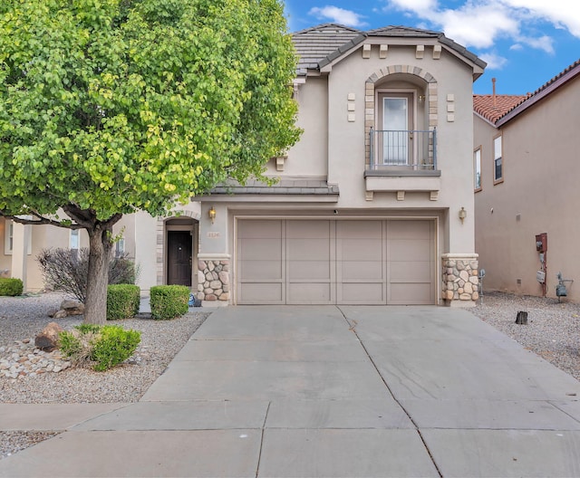 3536 Clear Creek Pl, Rio Rancho, NM 87144 - view of front of house featuring stone siding, concrete driveway, a garage, and stucco siding