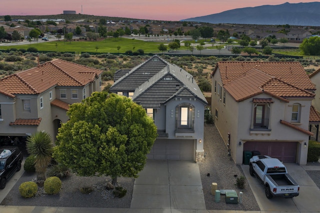 3536 Clear Creek Pl, Rio Rancho, NM 87144 - view of front of house featuring an attached garage, concrete driveway, a mountain view, a residential view, and stucco siding