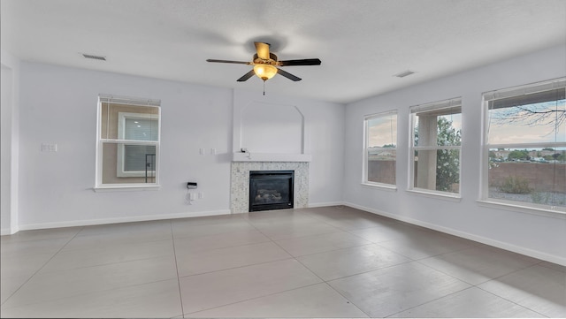 3536 Clear Creek Pl, Rio Rancho, NM 87144 - unfurnished living room with a tiled fireplace, ceiling fan, and tile patterned flooring