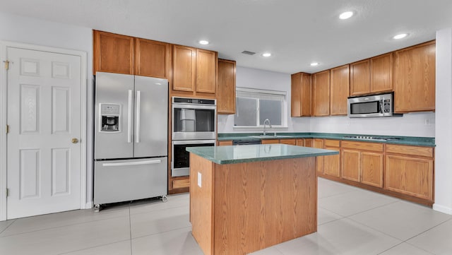 3536 Clear Creek Pl, Rio Rancho, NM 87144 - kitchen featuring appliances with stainless steel finishes, a kitchen island, dark countertops, light tile patterned floors, and recessed lighting
