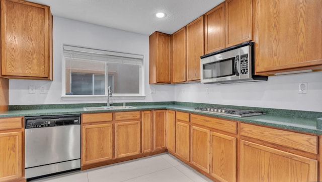 3536 Clear Creek Pl, Rio Rancho, NM 87144 - kitchen featuring stainless steel appliances, dark countertops, light tile patterned flooring, recessed lighting, and brown cabinets
