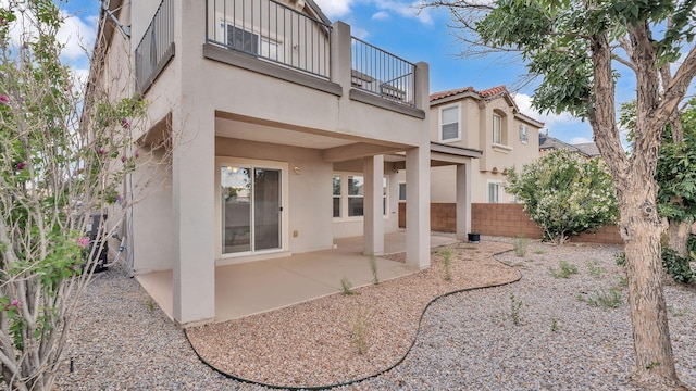 3536 Clear Creek Pl, Rio Rancho, NM 87144 - rear view of property featuring a balcony, stucco siding, a patio, and a fenced backyard