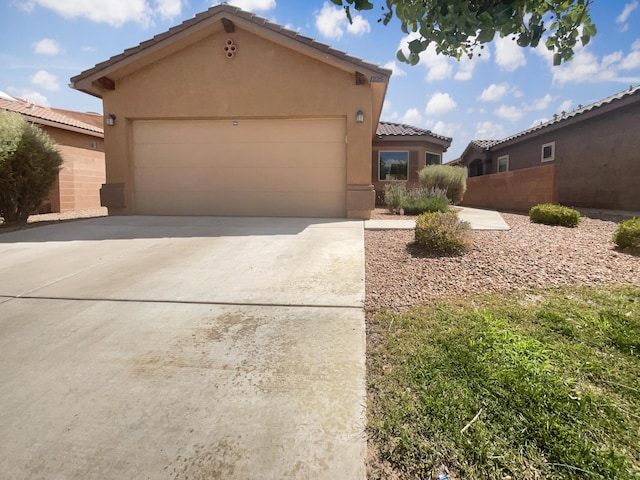 1225 La Fonda St, Bernalillo, NM 87004 - view of front of house featuring stucco siding, a tile roof, a garage, and concrete driveway