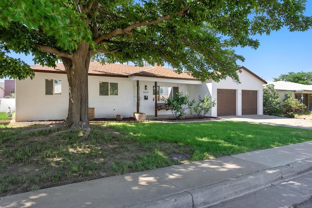 9638 Morrow Ave NE, Albuquerque, NM 87112 - ranch-style house with stucco siding, a front yard, an attached garage, and concrete driveway