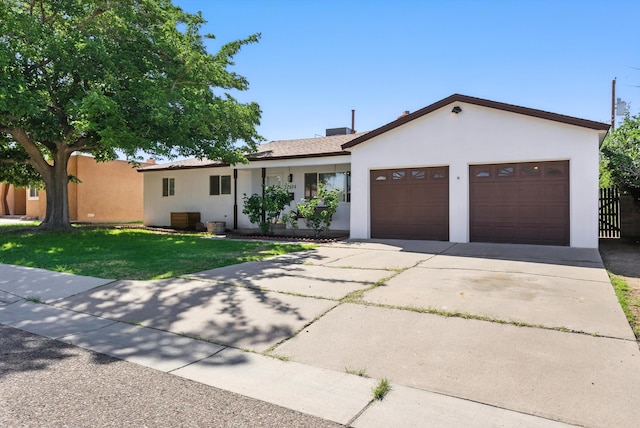 9638 Morrow Ave NE, Albuquerque, NM 87112 - ranch-style house featuring stucco siding, a front lawn, a garage, and concrete driveway