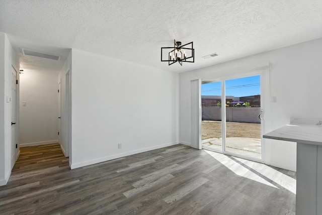 9638 Morrow Ave NE, Albuquerque, NM 87112 - unfurnished dining area with dark wood finished floors, a chandelier, and a textured ceiling