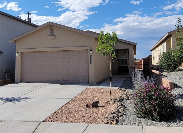 6383 Gannett Dr NE, Rio Rancho, NM 87144 - view of front of home with stucco siding, concrete driveway, and an attached garage