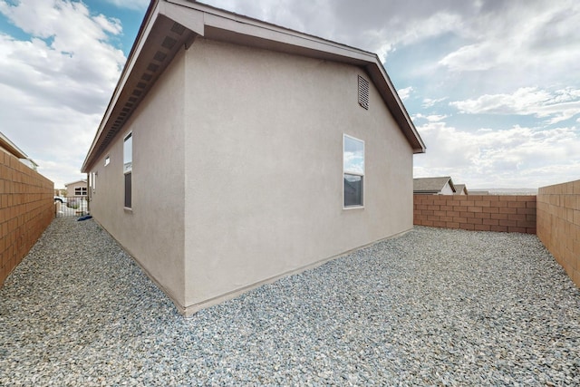 6383 Gannett Dr NE, Rio Rancho, NM 87144 - view of side of home featuring a fenced backyard and stucco siding