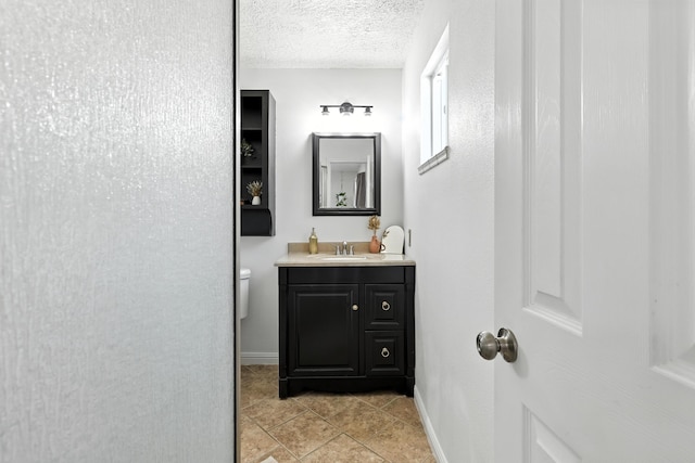 120 Itasca Rd SE, Rio Rancho, NM 87124 - bathroom with vanity, a textured ceiling, and tile patterned flooring