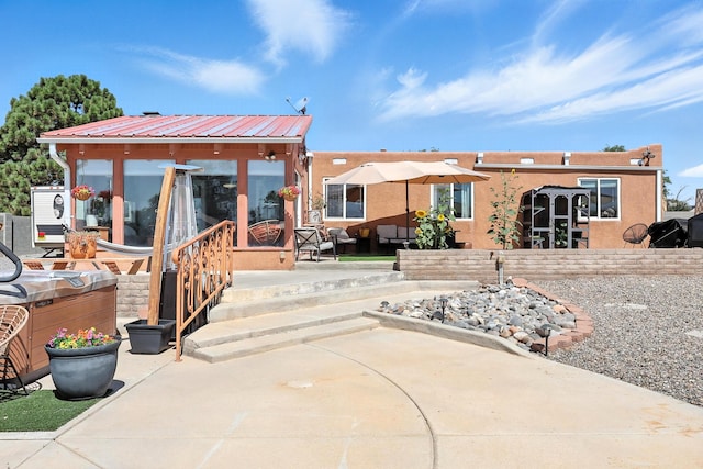 120 Itasca Rd SE, Rio Rancho, NM 87124 - back of property with a patio, a metal roof, and stucco siding