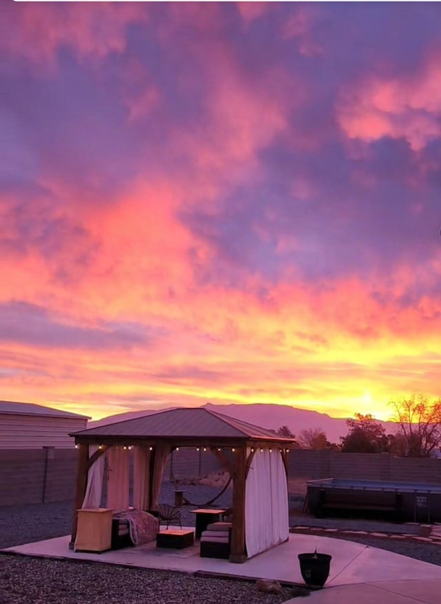120 Itasca Rd SE, Rio Rancho, NM 87124 - patio terrace at dusk with a gazebo, a patio area, and outdoor lounge area