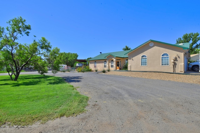 2 Partridge Ct, Peralta, NM 87042 - ranch-style house featuring driveway, stucco siding, a metal roof, and a front lawn