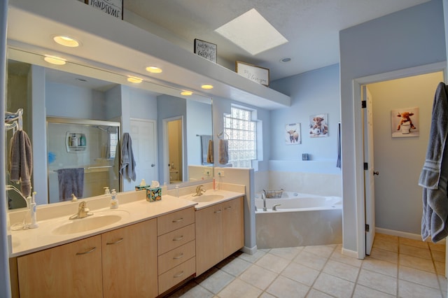 2 Partridge Ct, Peralta, NM 87042 - full bath with a garden tub, a skylight, double vanity, a stall shower, and tile patterned flooring