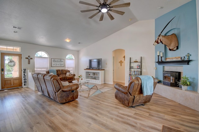 2 Partridge Ct, Peralta, NM 87042 - living room featuring a fireplace, arched walkways, ceiling fan, light wood-style flooring, and high vaulted ceiling