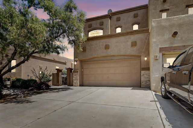 1969 Cortina Loop SE, Albuquerque, NM 87124 - view of front facade with concrete driveway, stucco siding, and a garage
