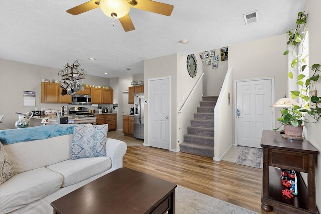 1969 Cortina Loop SE, Albuquerque, NM 87124 - living area featuring a ceiling fan, stairs, light wood-style flooring, and a textured ceiling