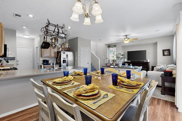 1969 Cortina Loop SE, Albuquerque, NM 87124 - dining room with wood finished floors, stairway, a chandelier, and a ceiling fan
