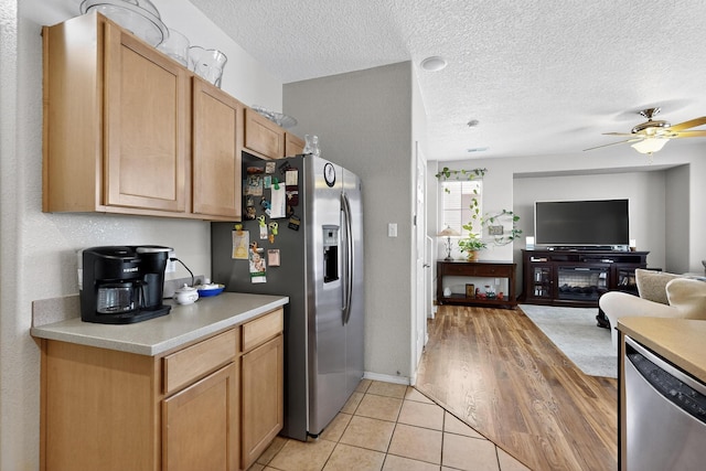 1969 Cortina Loop SE, Albuquerque, NM 87124 - kitchen featuring appliances with stainless steel finishes, light countertops, ceiling fan, a textured ceiling, and open floor plan