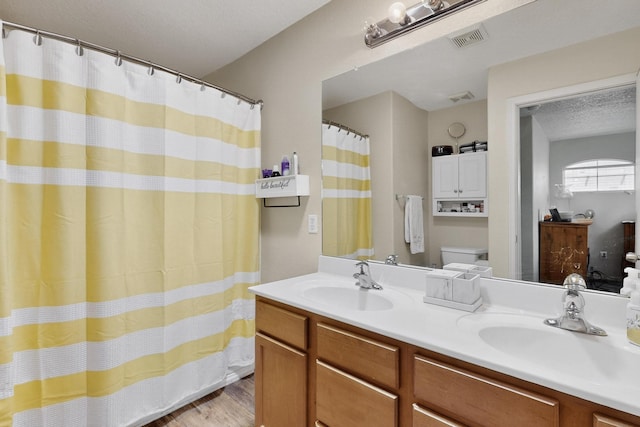 1969 Cortina Loop SE, Albuquerque, NM 87124 - bathroom with wood finished floors, double vanity, and curtained shower