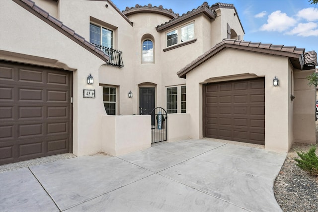 43 Vista Larga Pl NE, Rio Rancho, NM 87124 - mediterranean / spanish home featuring concrete driveway, a tile roof, and stucco siding