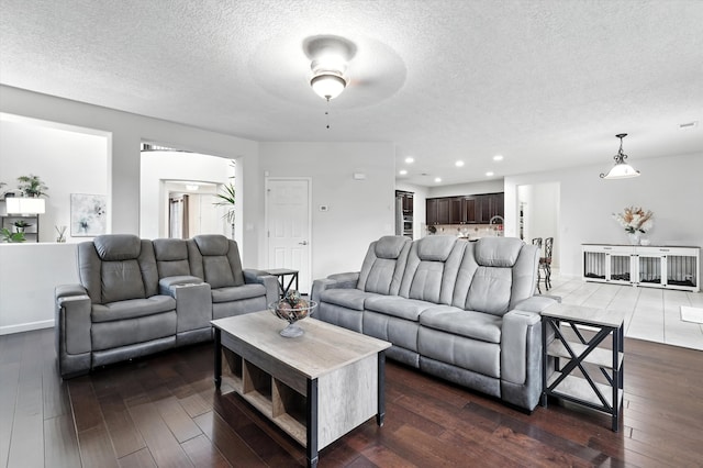 43 Vista Larga Pl NE, Rio Rancho, NM 87124 - living area with a textured ceiling, dark wood-style floors, recessed lighting, and a ceiling fan