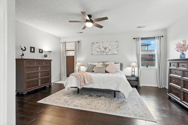 43 Vista Larga Pl NE, Rio Rancho, NM 87124 - bedroom with dark wood-type flooring, ceiling fan, and a textured ceiling