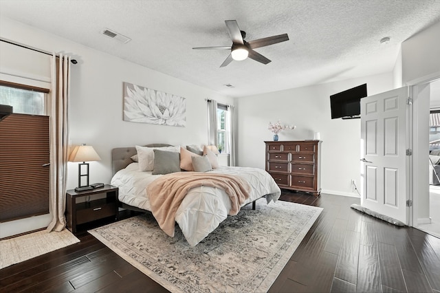 43 Vista Larga Pl NE, Rio Rancho, NM 87124 - bedroom with a textured ceiling, dark wood-style flooring, and ceiling fan