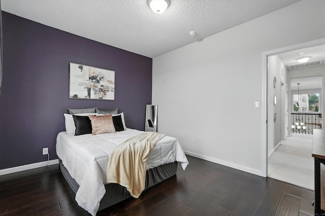 43 Vista Larga Pl NE, Rio Rancho, NM 87124 - bedroom with dark wood-type flooring and a textured ceiling