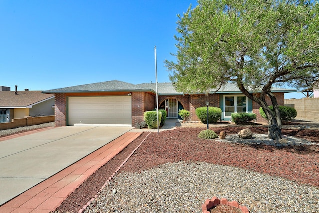 6054 Jack Rabbit Rd NE, Rio Rancho, NM 87144 - ranch-style home featuring concrete driveway, a garage, and brick siding