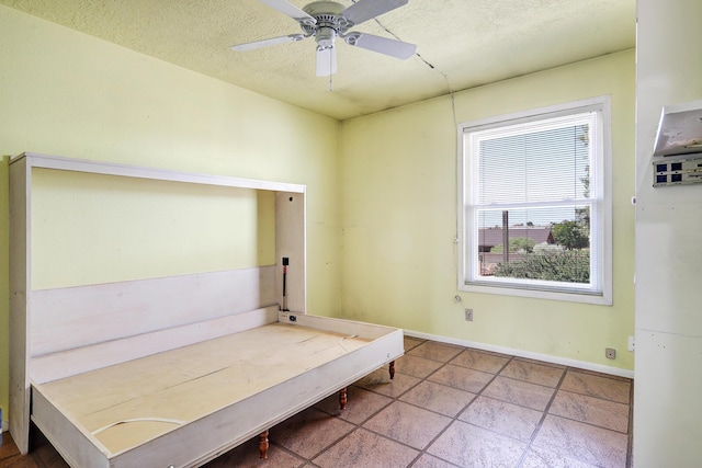 6054 Jack Rabbit Rd NE, Rio Rancho, NM 87144 - unfurnished bedroom with a textured ceiling and ceiling fan