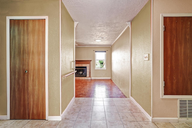 6054 Jack Rabbit Rd NE, Rio Rancho, NM 87144 - hallway featuring a textured wall, a textured ceiling, ornamental molding, and tile patterned floors
