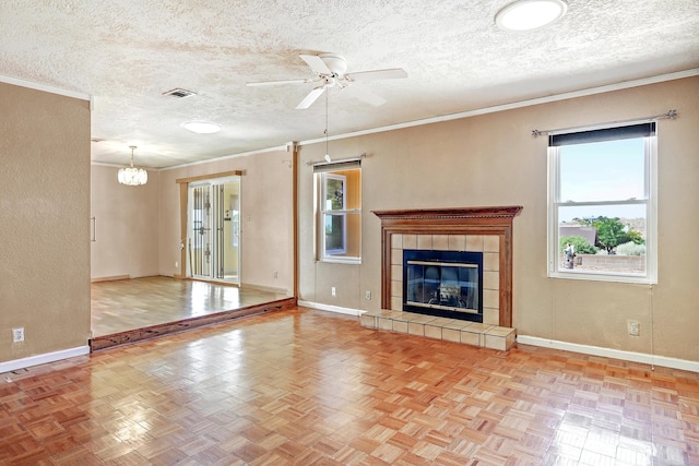 6054 Jack Rabbit Rd NE, Rio Rancho, NM 87144 - unfurnished living room with a ceiling fan, a chandelier, ornamental molding, a textured ceiling, and a fireplace