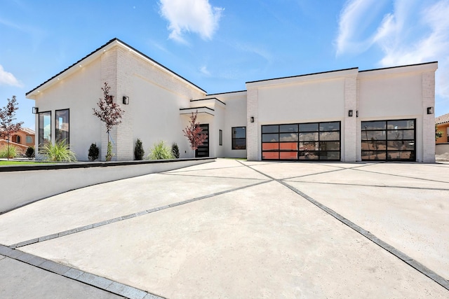 5624 Laredo, Rio Rancho, NM 87144 - modern home featuring stucco siding, concrete driveway, and a garage