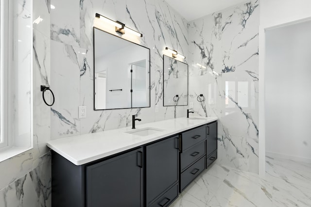 5624 Laredo, Rio Rancho, NM 87144 - bathroom featuring double vanity, marble tiled floors, and stone wall