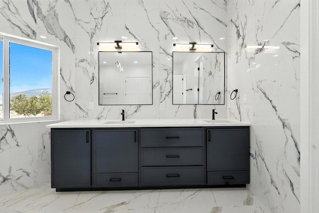 5624 Laredo, Rio Rancho, NM 87144 - bathroom featuring stone wall, double vanity, and marble tiled flooring